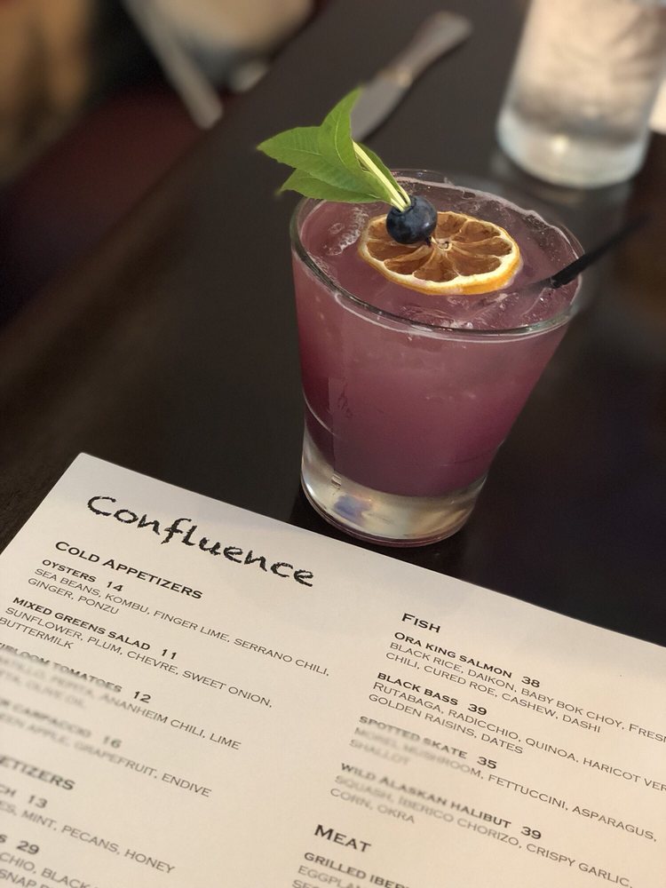 A house cocktail beside the Confluence menu