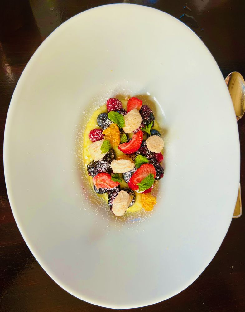 Citrus custard with fresh berries, mint and meringue