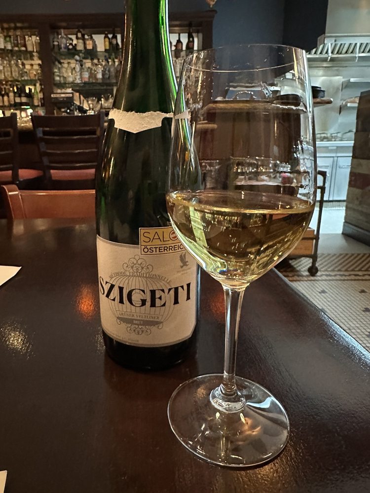 A glass of sparkling wine poured at the bar