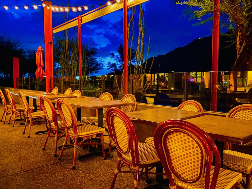 The Confluence patio at dusk under string lights