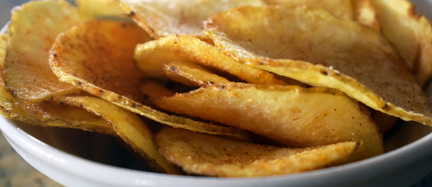 House-made barbecue potato chips in a white bowl