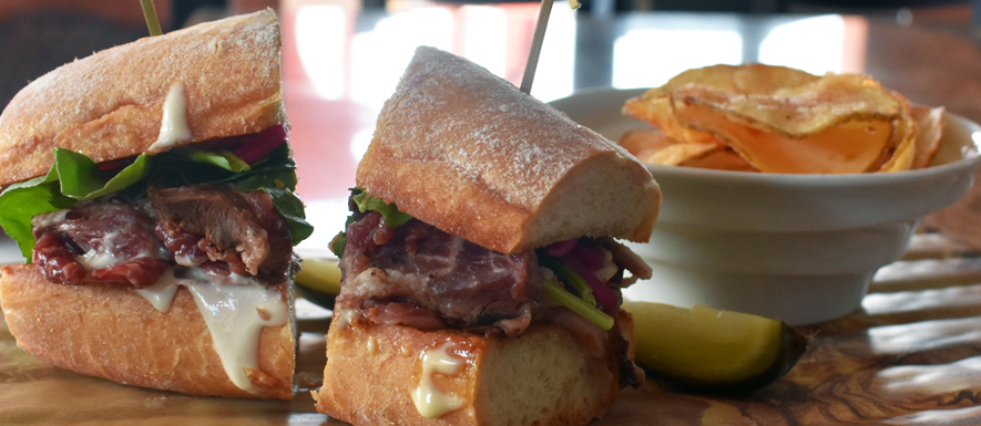 French dip sandwich on ciabatta with house chips